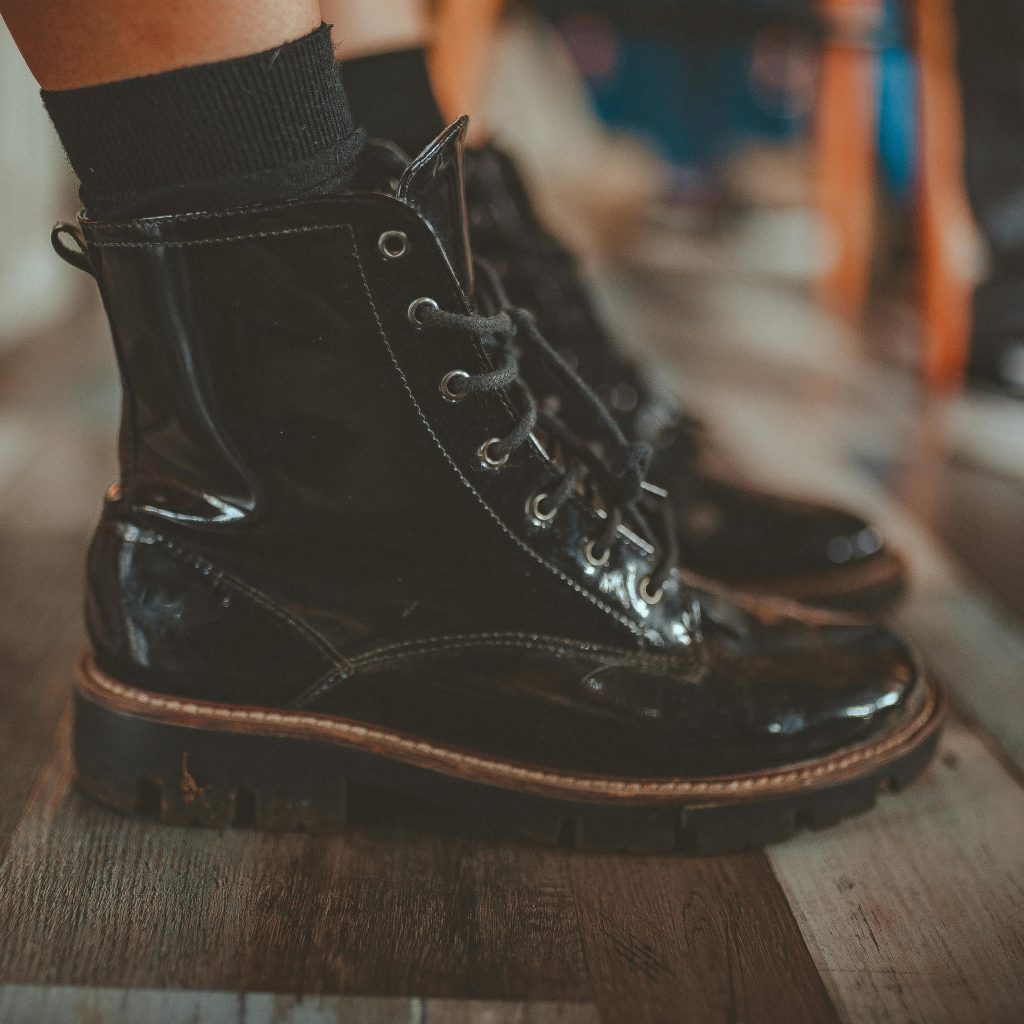 Stylish black leather boots with laces, captured in a fashionable close-up. Perfect footwear detail shot.